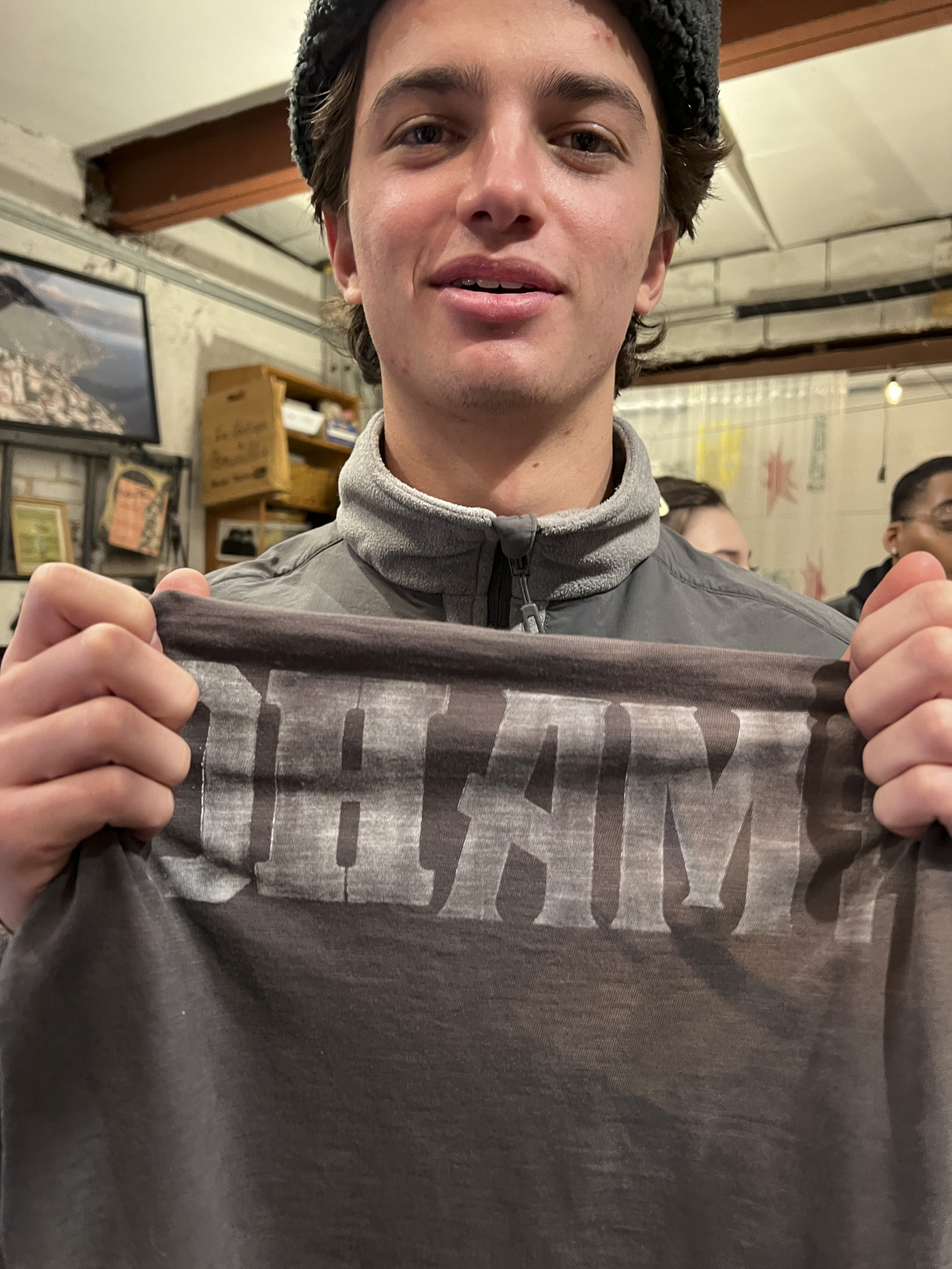 Tisch student holding a print made with hand-set type